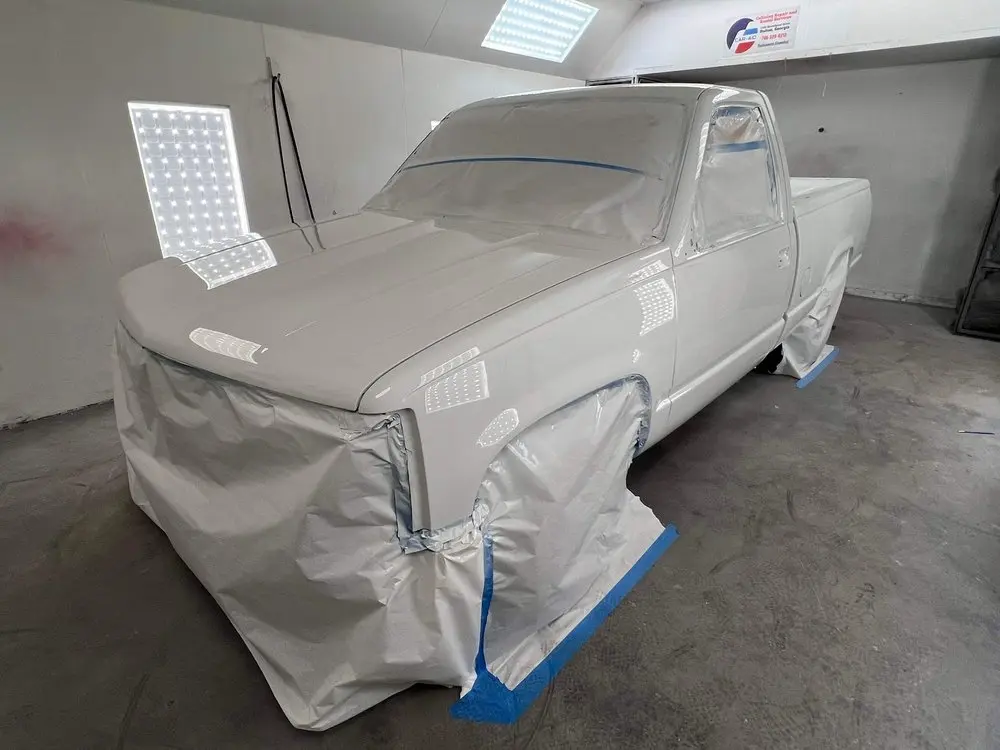 Pickup truck primed and masked for paint in the shop
