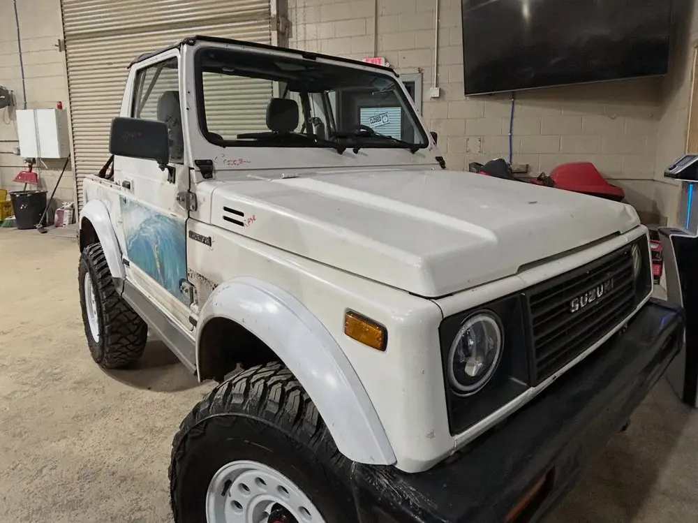 White Suzuki Samurai in the shop before its restoration